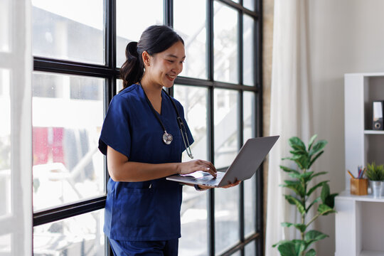 Asian woman doctor studying Learn about medical information. and all professions in documentation and research. researching content on laptop computer copy space, banner, panorama.
