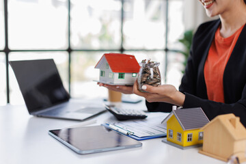 Female Real Estate Broker presenting and advised to model home and building project detail in the...