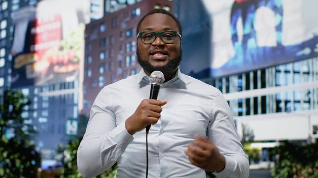 Journalist and communicator conducting on air segment on city street, holding microphone and sharing breaking news information. Dedicated media career presence, field work. Camera B.