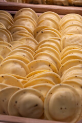 Fototapeta premium Fresh soft handmade Italian pasta tortellini, premium grano dura ingredients, flavors, texture for gourmet dining or classic family pasta meals
