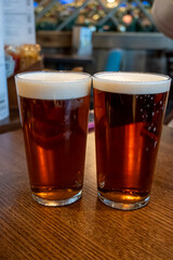 Classic London pub crawl with friends, enjoying cask ales and lively atmosphere of traditional...