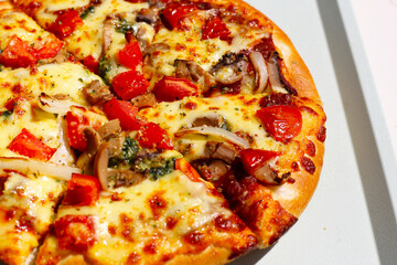 Vegetarian pizza topped with melted cheese, mushrooms, onions, and tomatoes.