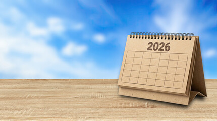 A calendar shows the year 2026 on a wooden table, created AI