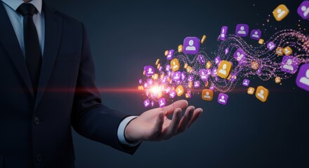 Businessmans hand holding a stream of glowing purple and orange user icons on a dark background