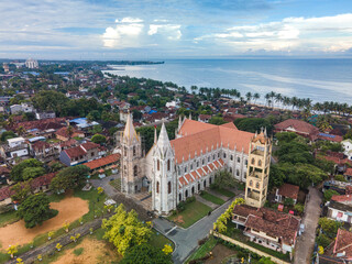 A drone photo of St. Sebastian's Church in Negombo, Sri Lanka.
The historic Catholic church, with its white fa&ccedil;ade and twin towers, is surrounded by a tropical cityscape.