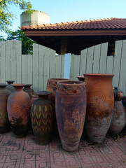 Traditional clay pottery jars displayed outdoors, showcasing rustic textures, handmade craftsmanship, and natural earth tones.