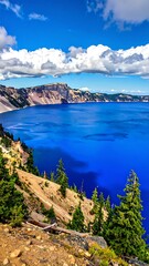 Azure lake beneath mountain cliffs and a bright blue sky with white clouds