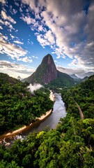 Lush, green, tropical landscape with a majestic peak, meandering river, and dramatic cloudscape under blue sky