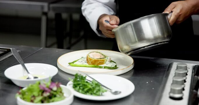 Culinary, plating or hands in restaurant with dish, catering or presentation in luxury cuisine. Hospitality, man or chef in kitchen with meal, dinner preparation or food decorating in fine dining.