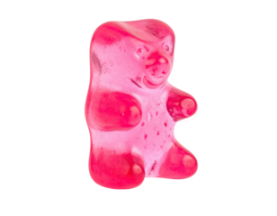 Single, bright pink gummy bear, translucent, against black