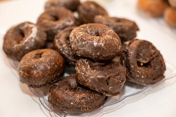 Stack of delicious fresh donuts on a plate 