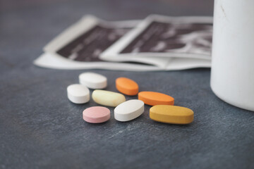 Different types of pills and a cup on a table