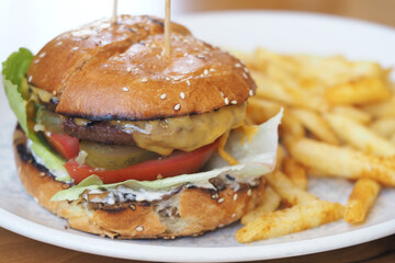 Tasty burger with fries served on a plate at a restaurant