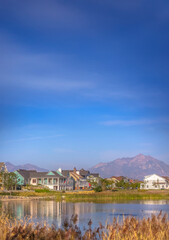 Fototapeta premium Lakefront homes along Oquirrh Lake on a sunny day
