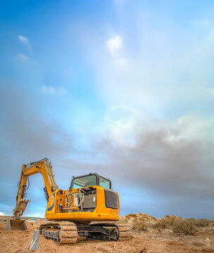 Excavator tractor seen from back with empty sky