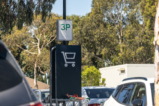 Designated shopping trolley parking sign installed in a suburban car park in Australia, marked with a 3P time limit sign above. Retail infrastructure, parking management, and suburban shopping
