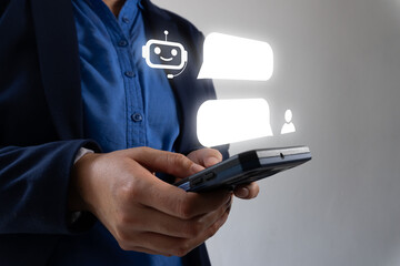 A person holding their phone, with an artificial intelligence chatbot interface floating above the...
