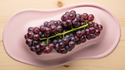 Artistic presentation of ripe grapes on a blush-colored serving plate