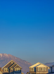 Close up of the upper storey of houses illuminated by sunlight on a sunny day