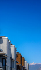 Row of homes with balconies and horizontal sidings