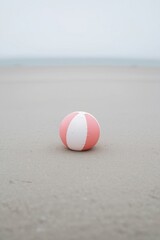 Single beach ball on sand