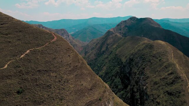 Wide-angle shot capturing the dramatic, rugged peaks and deep valleys of the Codo de los Andes mountain range in Bolivia.