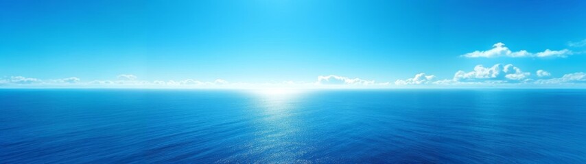 Obraz premium Wide panoramic view of calm ocean and expansive blue sky with soft clouds. Peaceful natural seascape background ideal for travel, wellness, nature, and copy space designs