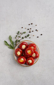 Red cherry peppers Sweet and spicy stuffed with cheese on ceramic plate. The milder "sister" of Peppadew.