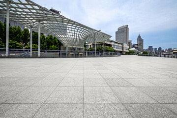 Fototapeta premium Empty square floor with modern architecture and city buildings in the background in Shanghai.