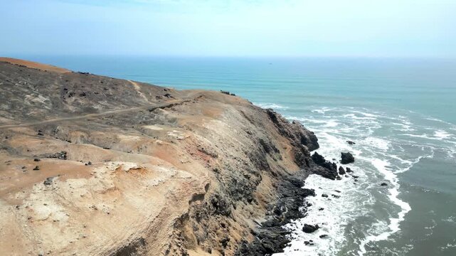 Aerial view of the coast of Eten, Lambayeque in northern Peru, with the lighthouse overlooking the Pacific Ocean and the arid coastal landscape in summer