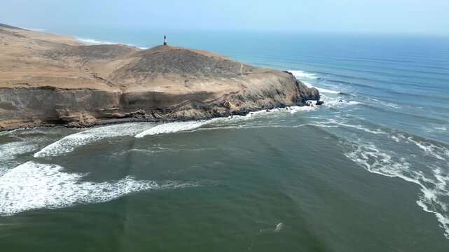 Aerial view of the coast of Eten, Lambayeque in northern Peru, with the lighthouse overlooking the Pacific Ocean and the arid coastal landscape in summer