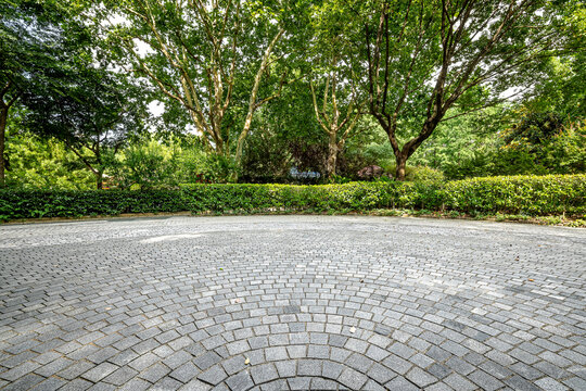 Empty square floor in a green park.