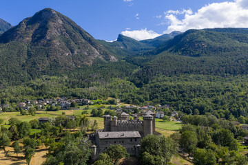 Fototapeta premium Fenis Castle and Alpine valley landscape - Fenis, Italy