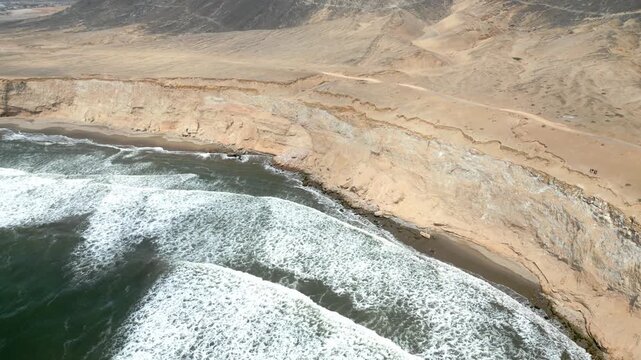 Aerial view of the coast of Eten, Lambayeque in northern Peru, with the lighthouse overlooking the Pacific Ocean and the arid coastal landscape in summer