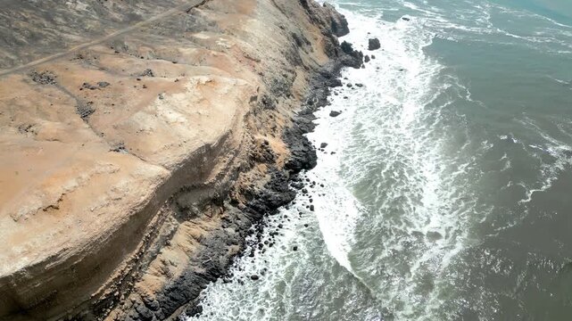 Aerial view of the coast of Eten, Lambayeque in northern Peru, with the lighthouse overlooking the Pacific Ocean and the arid coastal landscape in summer