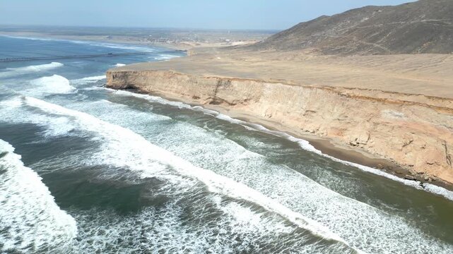 Aerial view of the coast of Eten, Lambayeque in northern Peru, with the lighthouse overlooking the Pacific Ocean and the arid coastal landscape in summer