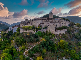Aerial view of Arrone medieval hilltop village with castle in Valnerina valley Umbria Italy Dramatic sunset sky