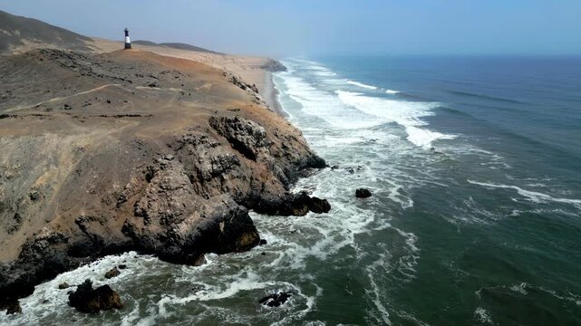 Aerial view of the coast of Eten, Lambayeque in northern Peru, with the lighthouse overlooking the Pacific Ocean and the arid coastal landscape in summer