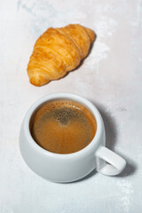 espresso and fresh croissant, vertical top view
