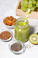 healthy superfood - green smoothie made from fruits and herbs, vertical top view