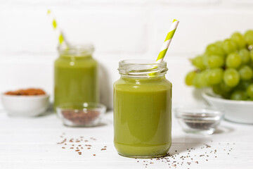healthy superfood - green smoothie with chia seeds, closeup