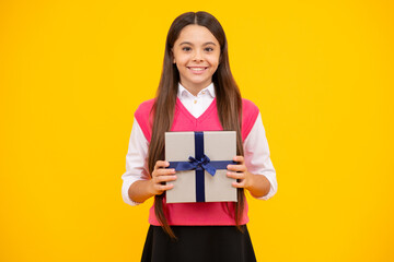 Teenager girl hold gift box. Child holding gift box in Christmas or birthday. Girl with giftbox for mothers day. Portrait of a little girl with a gift on isolated background. Birthday, presents gift.
