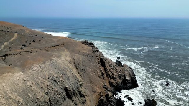 Aerial view of the coast of Eten, Lambayeque in northern Peru, with the lighthouse overlooking the Pacific Ocean and the arid coastal landscape in summer