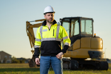 Worker at construction site. Builder in hardhat. Construction man with helmet. Worker at construction with helmet. Industry worker at construction building. Builder at site building with excavator.