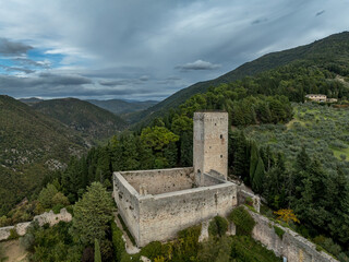 An aerial view of Assisi Rocca Minore medieval castle protecting the town from the hills with square tower in Umbria Italy