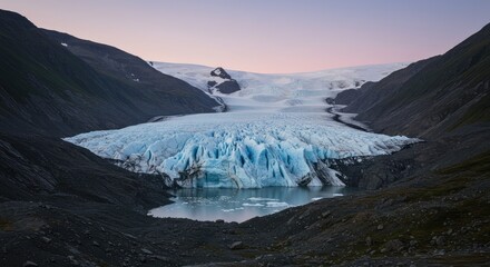 Glacial landscape at dawn.  Vast glacier flows into a tranquil lake