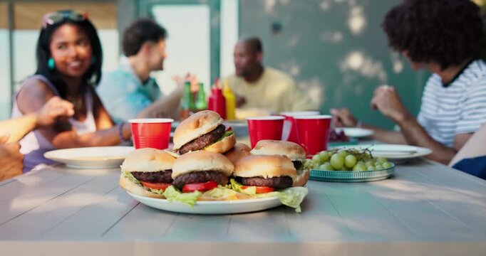 BBQ, food and friends with hamburgers in backyard for social gathering, new years party or reunion. Summer holiday, people or barbecue lunch outdoor at house for weekend break, celebration or cookout