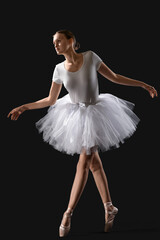 Naklejka premium Young ballerina on dark background