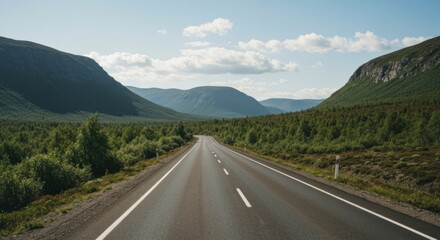 Fototapeta premium Empty highway winds through green mountains
