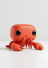 Vibrant red lobster toy on white backdrop with selective focus